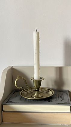 a lit candle sitting on top of a book