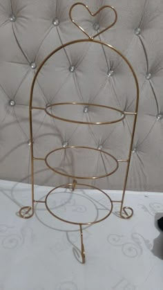 a gold metal stand with hearts on it