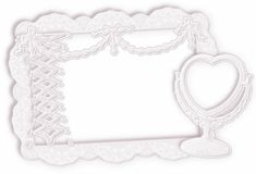 an ornate frame with a heart on the top and a lace border around it, in white