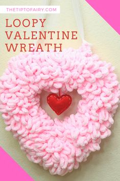 a knitted wreath with a red heart hanging from it's center and text loopy valentine wreath