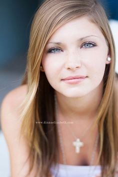 a beautiful young woman with blue eyes and long blonde hair posing for a studio photo