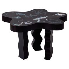 a small black table with an artistic design on it