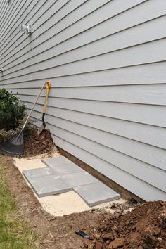 a shovel is laying on the ground in front of a house