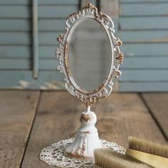 a small mirror sitting on top of a wooden table