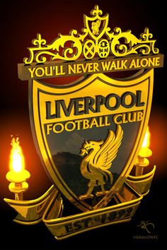 the liverpool football club crest with candles in front of it and an inscription that reads you'll never walk alone