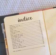 an open notebook with the words indice written on it and a pen next to it