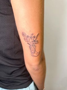 a woman with a flower tattoo on her arm