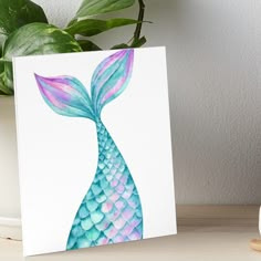 a painting of a blue and pink mermaid tail on a white background art board print