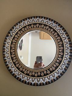 a round mirror hanging on the side of a wall