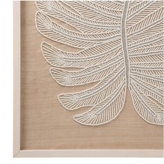 a white embroidered leaf in a frame