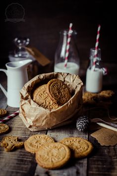 some cookies and milk on a wooden table