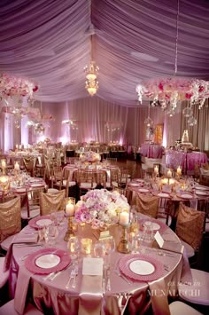 the centerpieces and tables are set up for an elegant wedding reception with crystal chandeliers