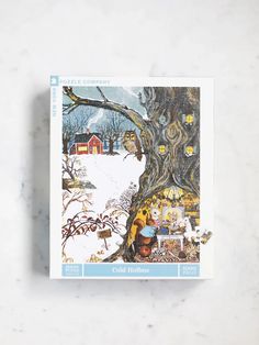 the puzzle company christmas card is shown on a marble surface with a tree and house in the background