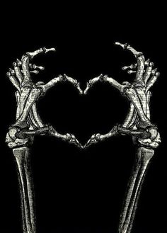 two hands making a heart shape with their fingers on top of each other in front of a black background