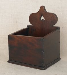 an old wooden box with some sort of object in it's holder on a white background