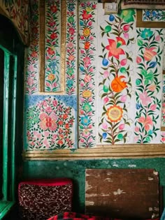 the wall is covered with colorful flowers and leaves