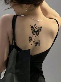 the back of a woman's shoulder with butterfly tattoos on her upper and lower arm