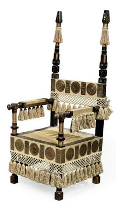 an old chair with tassels on it