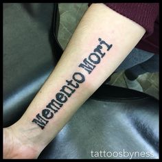 a person with a tattoo on their arm that says memechomor in cursive font