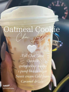 someone holding up a cup of coffee with the words oatmeal cookie on it