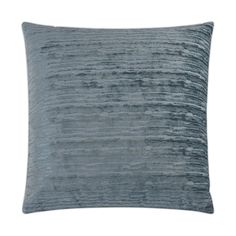 a blue velvet pillow on a white background