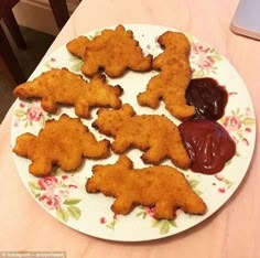 a white plate topped with cut out animals next to jelly ketchup on a table