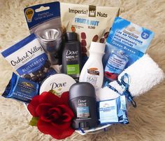 a basket filled with personal care items on top of a white blanket next to a red rose