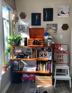 a room filled with lots of clutter and books on top of a wooden shelf