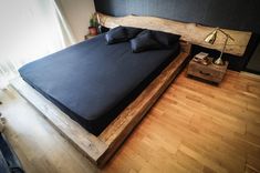 a large bed sitting on top of a wooden floor