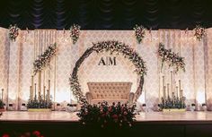 the stage is decorated with flowers and greenery