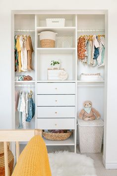 a baby's closet with clothes, toys and other items on shelves next to a crib