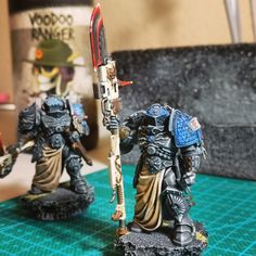 two warhammers are standing on a table