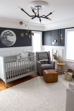 a baby's room with a crib, rocking chair and ottoman in it