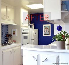 a kitchen with blue walls and white cabinets