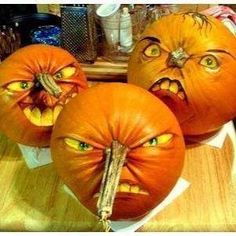 three pumpkins that have been carved to look like they are frowning and looking at the camera