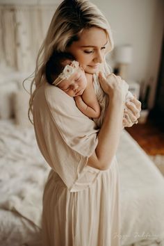 a woman holding a baby in her arms