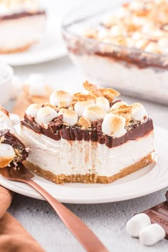 a piece of dessert on a plate with a fork and spoon next to the pie