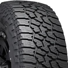 an all terrain tire on a white background