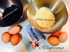 eggs and other ingredients are in bowls on a counter top next to a packet of chocolate chips