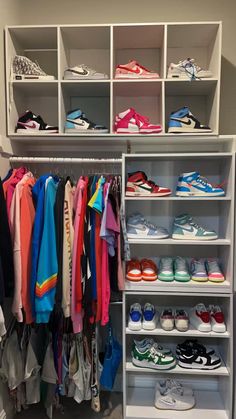 a closet filled with lots of shoes and t - shirts