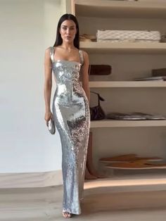 Expertly designed for a stunning and sophisticated look, the Socialite Silver Sequin Cut Out Sleeveless Maxi Dress is a must-have for any glamorous occasion. The intricate sequin detailing adds a touch of sparkle, while the cut-out sleeves and maxi length create an effortlessly chic silhouette. Elevate your style with this elegant dress. 100% Polyester Dry Clean Zipper Closure Due To High Demand-Please Allow 2-3 Weeks For Delivery Brand Size Dress Bust Waist Hip XS 0-2 31-32.5'' 23-24'' 31-34" S Glamorous Fitted Sleeveless Dress For Prom, Glamorous Fitted Sleeveless Dress For Prom Season, Glamorous Fitted Sleeveless Dress For Gala, Glamorous Sleeveless Dress For Evening Parties, Glamorous Strapless Sleeveless Party Dress, Sleeveless Sequin Dress For Prom Party, Sleeveless Sequin Dress For Party During Prom Season, Sleeveless Sequin Dress For Party And Prom Season, Glamorous Sleeveless Evening Dress