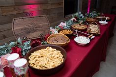 a long table with many different types of food on it and decorations around the tables