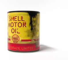 an old shell motor oil can sitting on a white surface