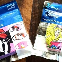 two bags of face masks on a wooden table with the packaging showing them as princesses