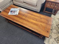 a living room with two couches, a coffee table and a rug on the floor