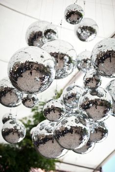 a bunch of shiny balls hanging from the ceiling