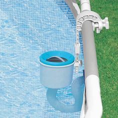 a blue and white pool sprinkler next to the edge of a swimming pool