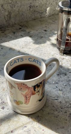 a cup of coffee sitting on top of a counter