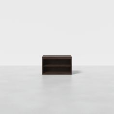 an empty shelf sitting on top of a white floor