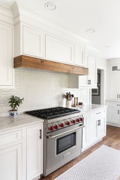 a kitchen with white cabinets and an oven